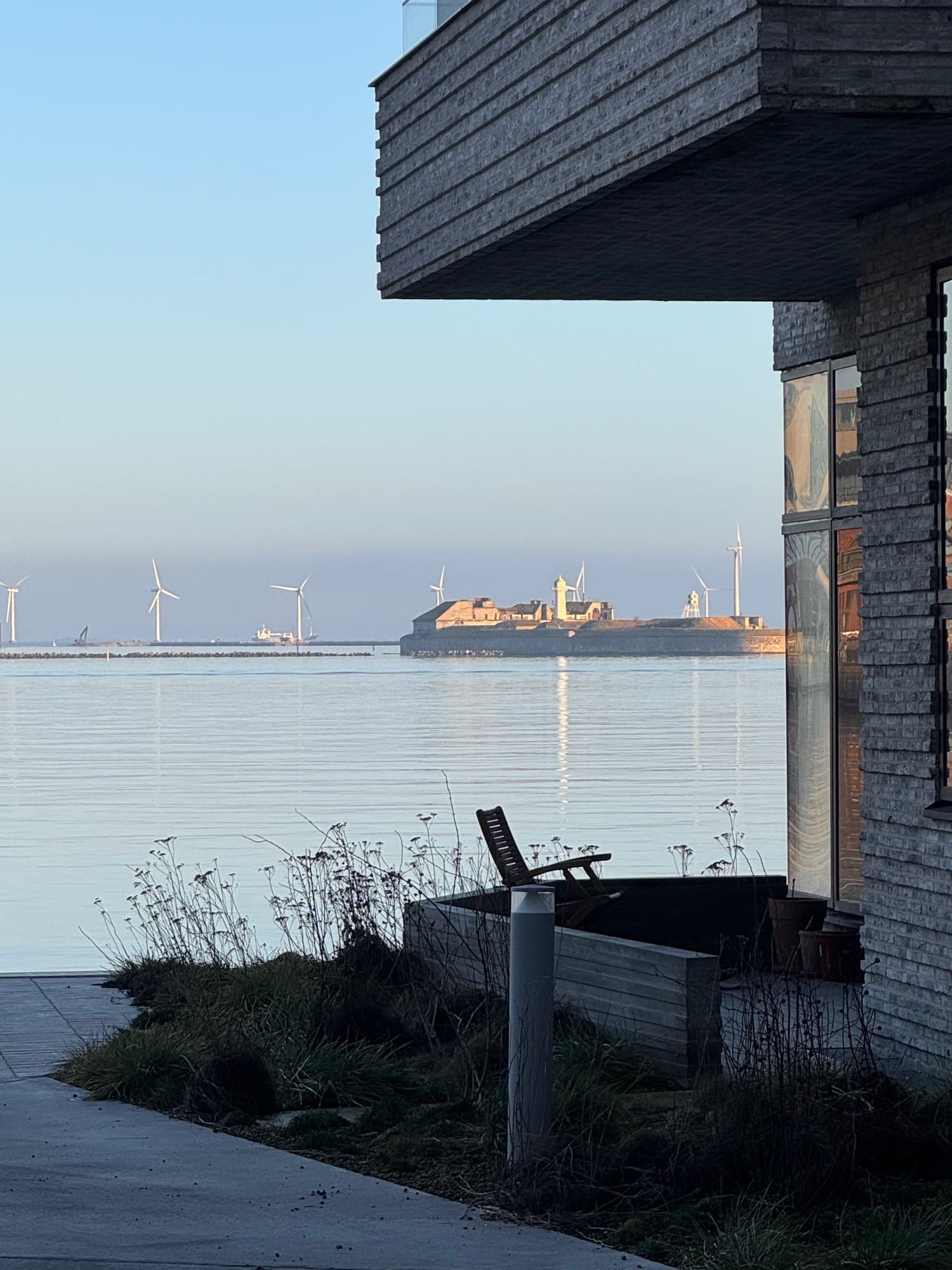 The fort seen between harbour buildings at low winter sun